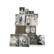 A photograph album containing a quantity of black and white photographs with facsimilie signatures