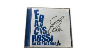 A copy of Status Quo's Francis Rossi: One Step at a Time CD, signed by Rossi in black ink.