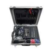 A silver flight case containing various professional microphones, cables and accessories.