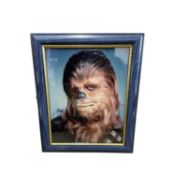 A framed 8x10" colour photograph, bearing the signature of Star Wars' Chewbacca, Peter Mayhew (