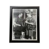 A framed 8x10" black and white photograph, bearing the signature of James Bond's Q, Desmond Llewelyn