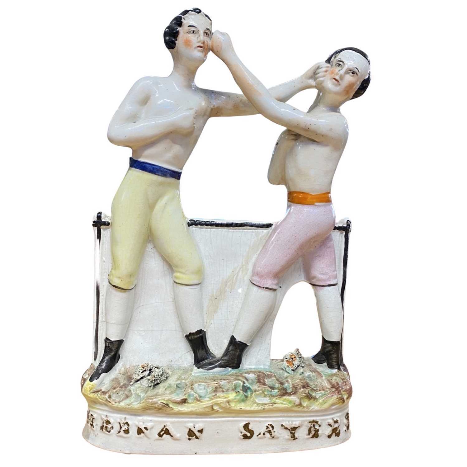 A Staffordshire figure of Heenan and Sayers, boxing group, mid/late 19th Century. The boxing match