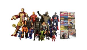 A mixed lot of various DC/Marvel figurines and books, to include Batman, Iron Man, Spider Man, Thor,
