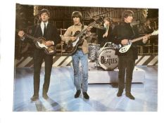 A collection of Beatles photographic and advertising posters