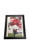 A framed and glazed 8x10'' photograph bearing the signature of Manchester United's Cristiano Ronaldo