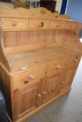 Modern pine low back kitchen dresser, the top section with four small drawers over a base with three