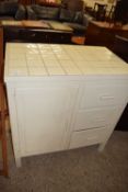 Cream painted tile top cabinet