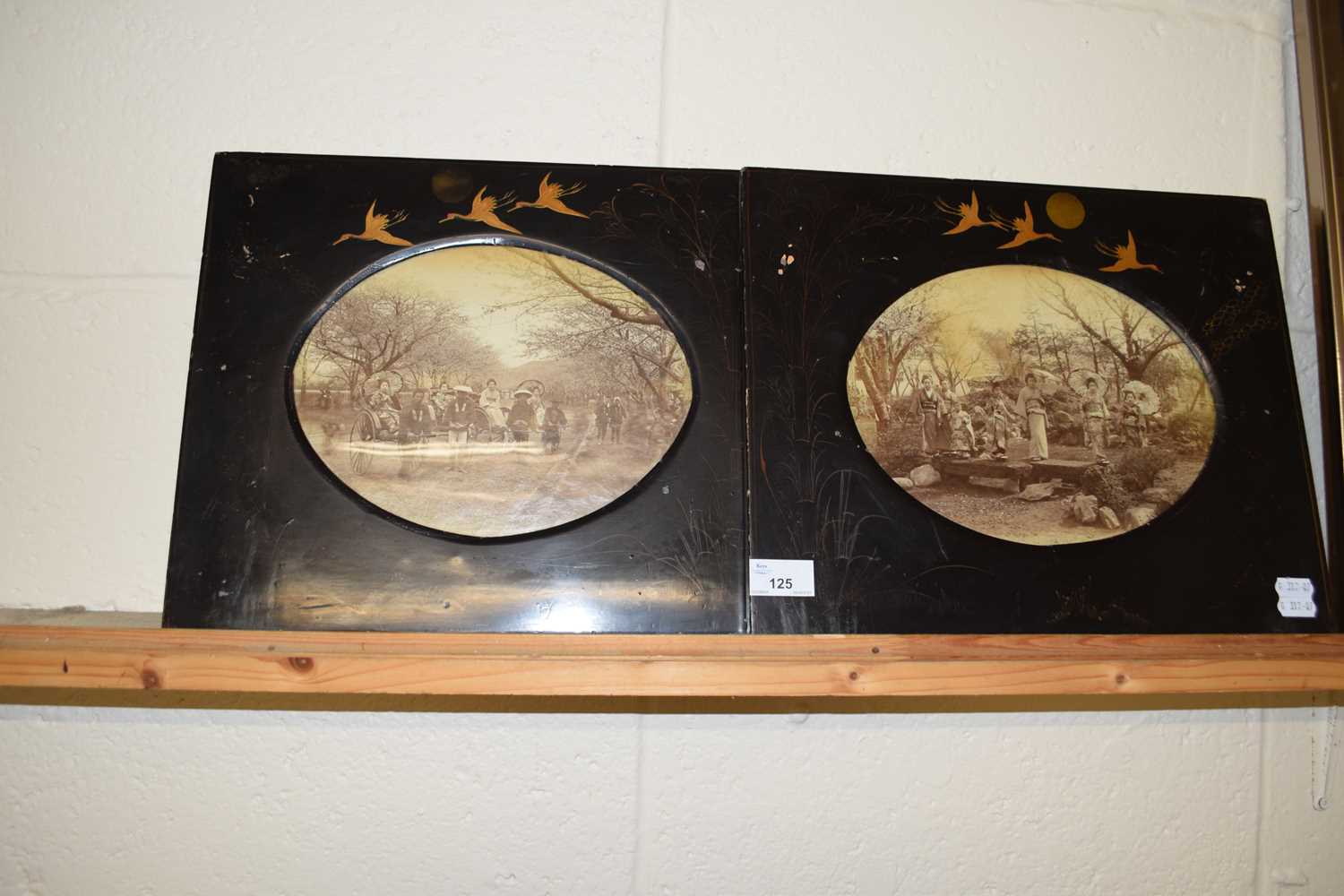 Pair of Japanese black lacquered photograph frames decorated with cranes containing vintage black