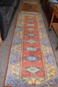 20th Century floor runner carpet decorated in mainly pale blue, yellow and red, 255 x 87cm plus a