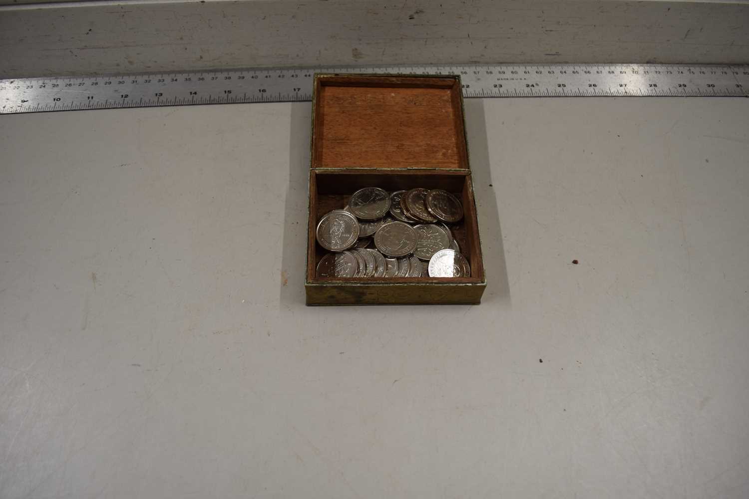 A small case containing Makers of the Millennium silver plated tokens