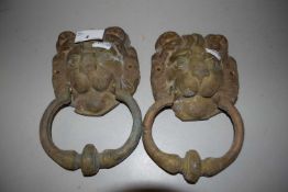 A pair of iron lions head door knockers