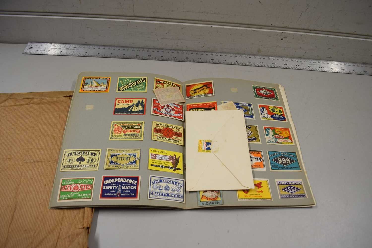 Scrap album containing a collection of various match box labels