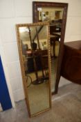 Two 20th Century rectangular wall mirrors, one in a carved frame, the other in a gilt effect frame