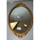 Small oval wall mirror in gilt effect frame