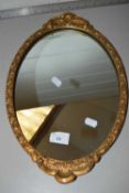 Small oval wall mirror in gilt effect frame