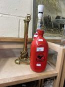 A brass lamp stand, a novelty glass wine bottle lamp stand and a red water bottle (3)