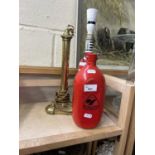 A brass lamp stand, a novelty glass wine bottle lamp stand and a red water bottle (3)