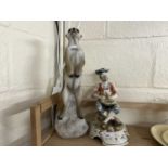 Resin model of a meerkat and a pottery figure of a seated fisherman