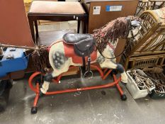 Retro rocking horse on metal stand