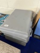 Three grey plastic cases