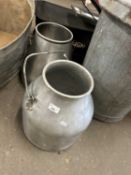 Two small milk churns