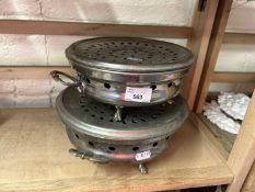 Two white metal plate warmers