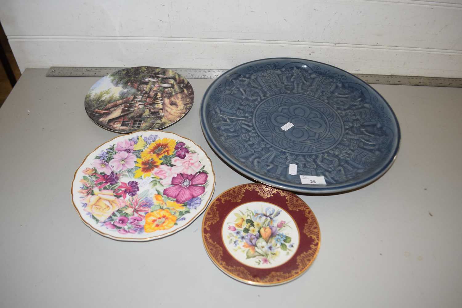 A pale blue Thai ceramic charger and three collectors plates