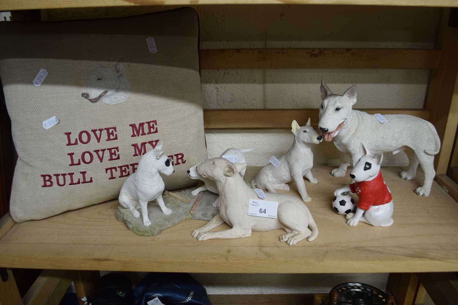 A quantity of Bull Terrier figurines together with a Bull Terrier cushion