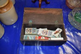 Box containing a quantity of cigarette packets and cards