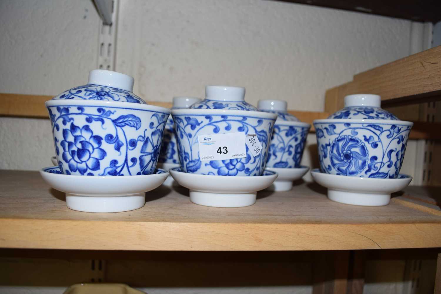 Six modern blue and white tea bowls, saucers and covers