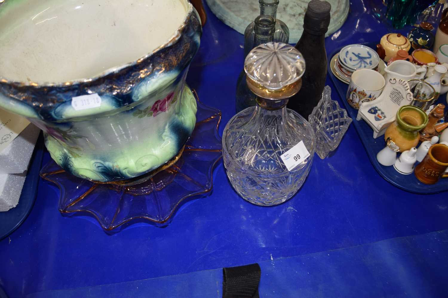 A glass decanter with silver collar together with a jardiniere and other items