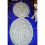 Pair of oval plaster wall plaques with painted finish