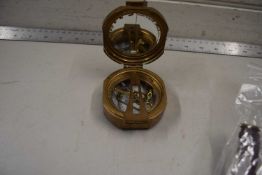 A brass cased compass with hinged lid marked No.777, 7cm wide