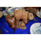 Carved stone elephant and four carved wooden elephants