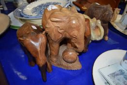 Carved stone elephant and four carved wooden elephants