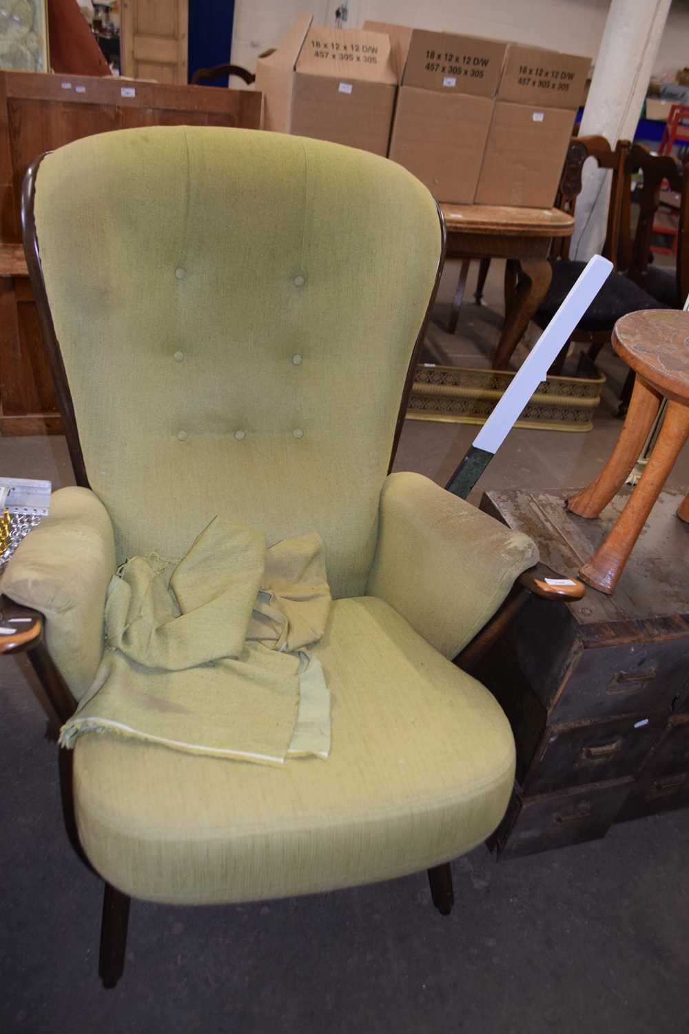 An olive green upholstered easy chair