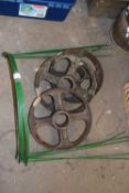 Three cast iron wheels and a quantity of green half hoop garden stakes