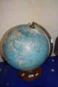 A globe on circular wooden base