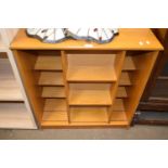 Bookcase with central sliding three tier shelf to front, 74cm wide