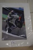 A signed photograph of a racing motorcyclist