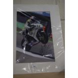 A signed photograph of a racing motorcyclist