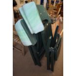 Three green folding garden chairs with cushions