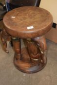 A side table/stool carved with elephants