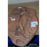Carved terracotta plaque of a young girl, 28cm long