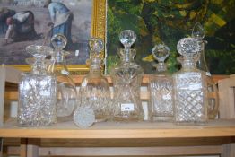 Quantity of cut glass decanters of various shapes and sizes