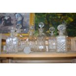 Quantity of cut glass decanters of various shapes and sizes