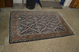 20th Century machine made wool floor rug with geometric design on a blue background, 212 x 135cm