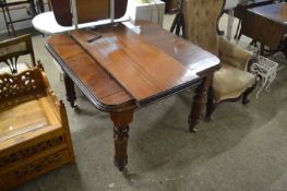 Mahogany extending dining table on turned legs and casters, 100cm wide