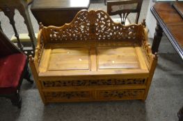 20th Century hardwood settle with pierced carved floral detail, 97cm wide