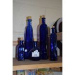 Five various blue glass bottles